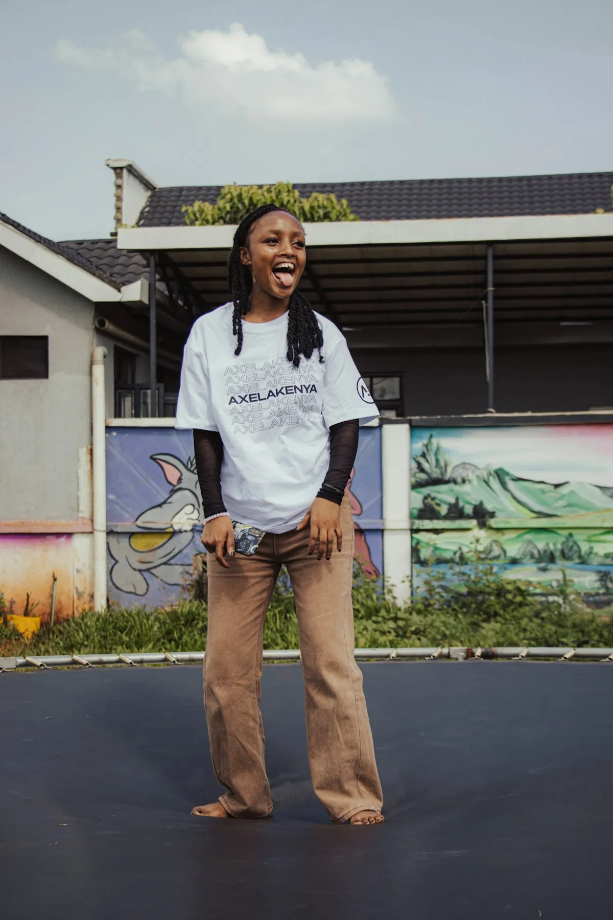 A young person mid-bounce on a trampoline, grinning