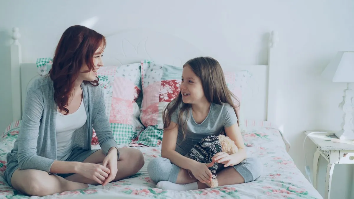 A mother and teenage daughter having a conversation on a couch