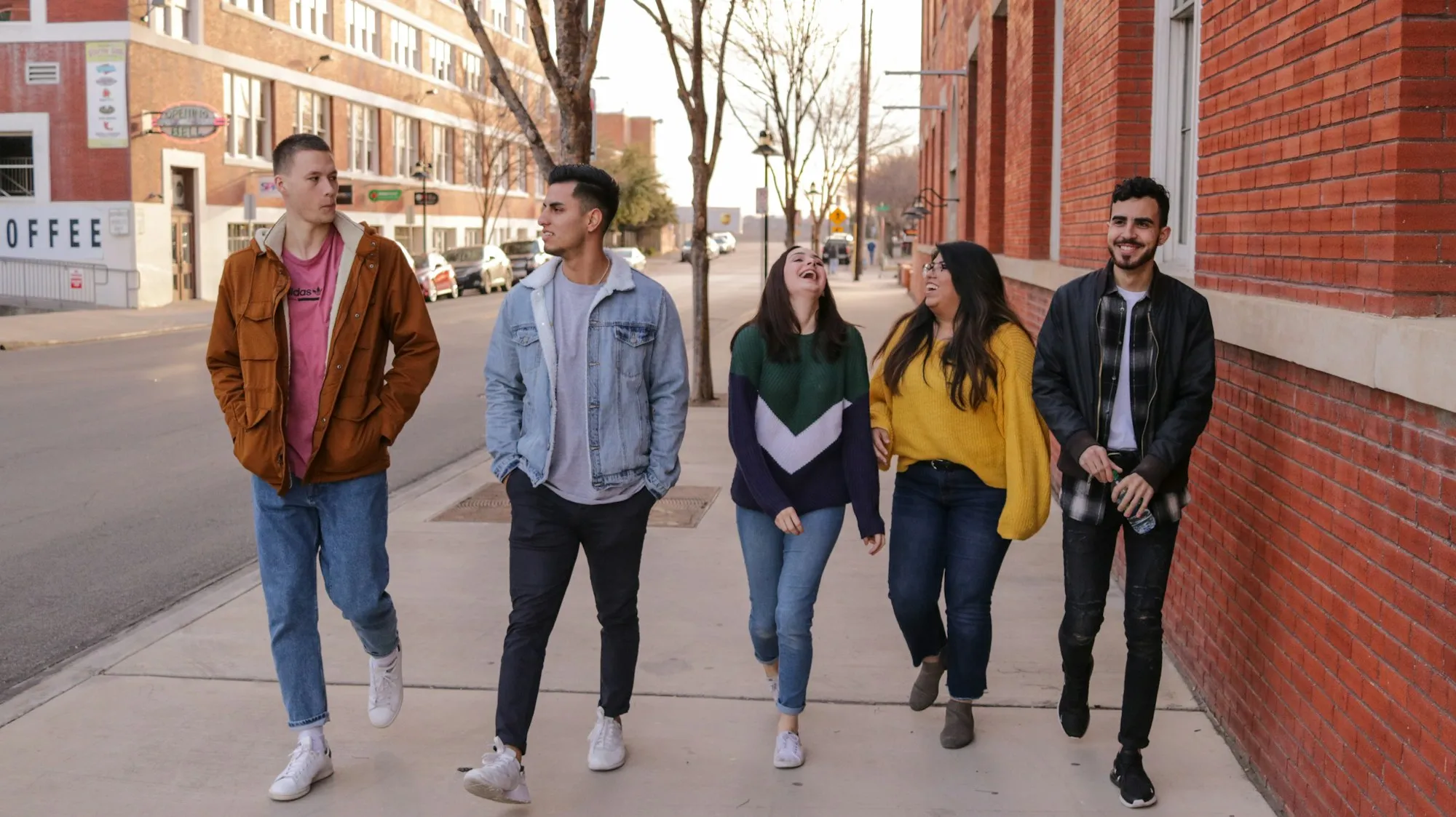 A group of teenagers walking and laughing together outdoors